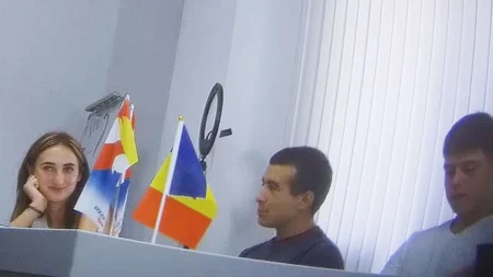 Координатор Алёна Юк за рабочим столом с флагами во время тайной съёмки BBC