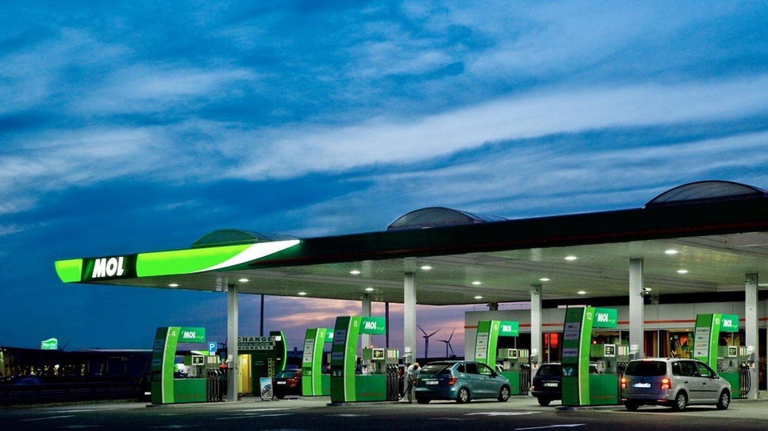 Автозаправочная станция MOL с зелёной подсветкой в сумерках