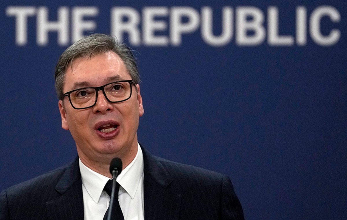 Vucic speaking at official press conference with 'THE REPUBLIC' text behind