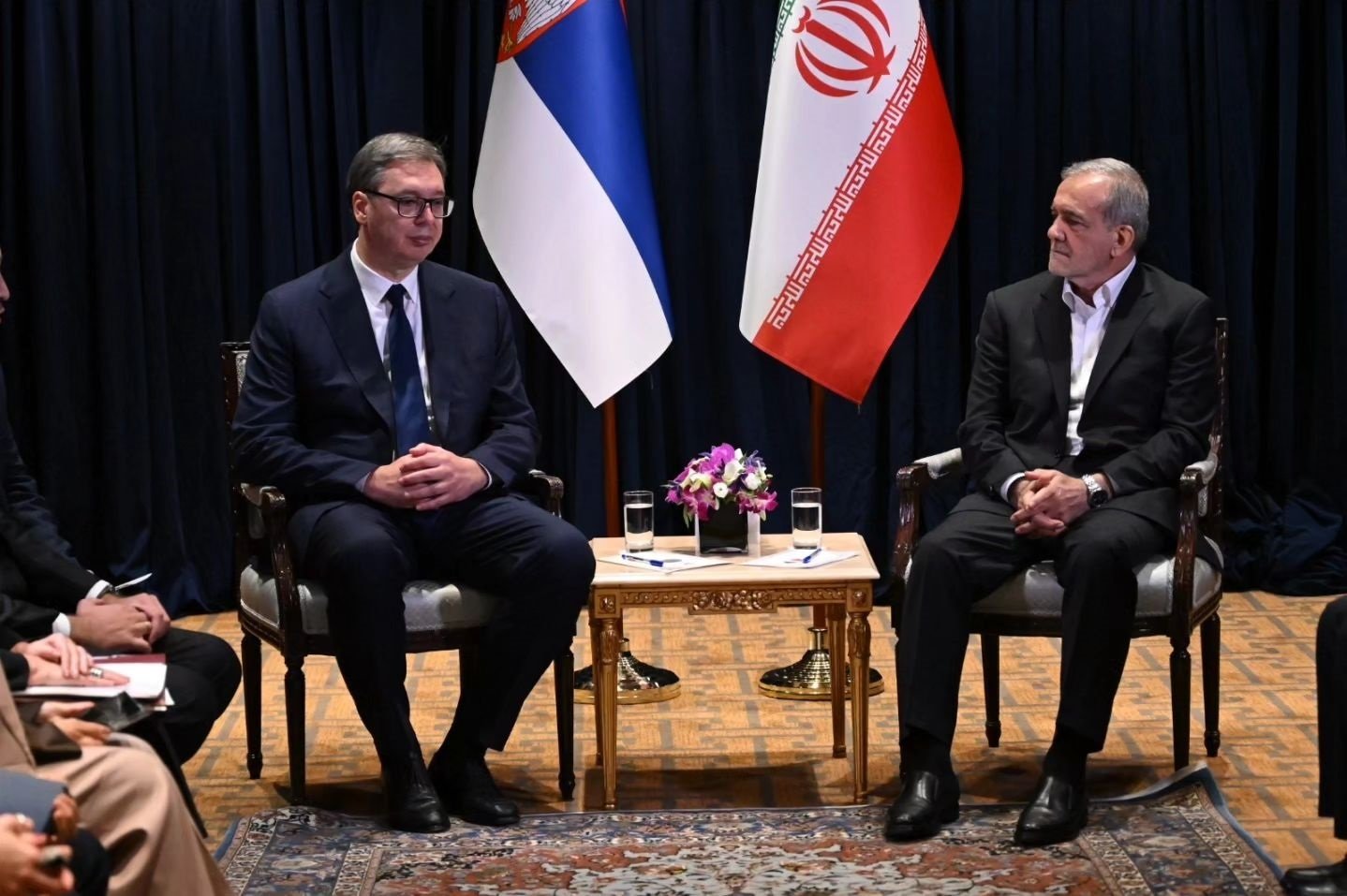 Vucic meeting with Iranian president, Serbian and Iranian flags in background