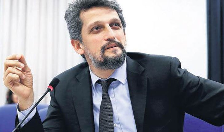 Garo Paylan speaking at a microphone, portrait style