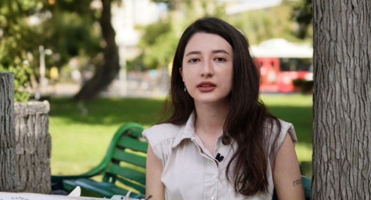 Female trade union activist sitting in park during interview