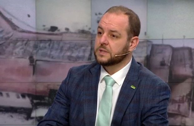 Борислав Сандов во время интервью в телестудии, в костюме с зеленым галстуком