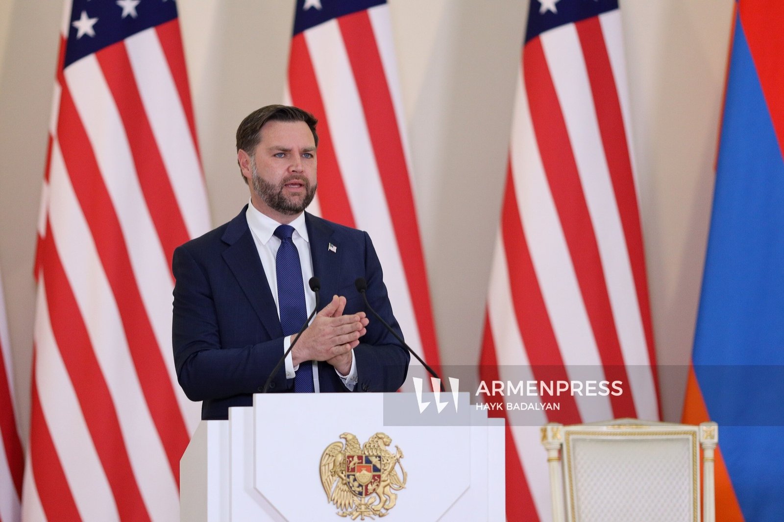US Vice President JD Vance speaking at a podium with American and Armenian flags behind him during his visit to Yerevan
