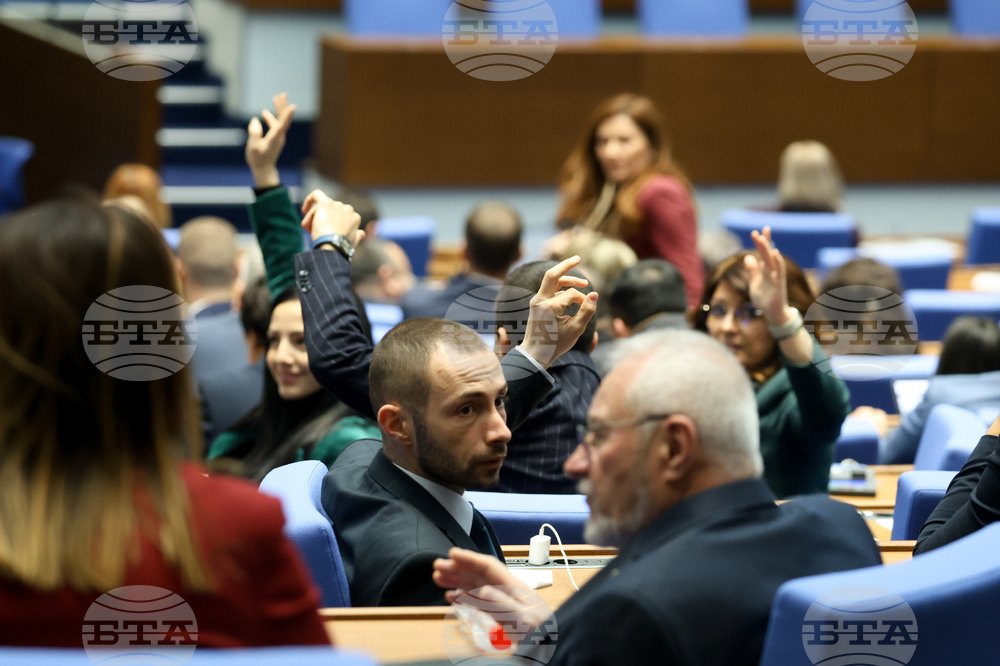 Bulgarian MPs raising hands to vote during a parliamentary session