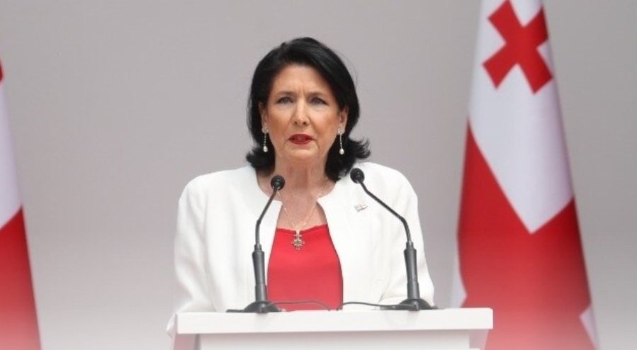 Salome Zourabichvili, former Georgian president, at podium with Georgian flags