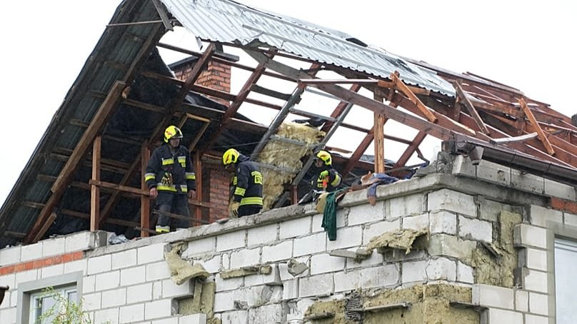 Firefighters inspecting building damaged by drone in Poland