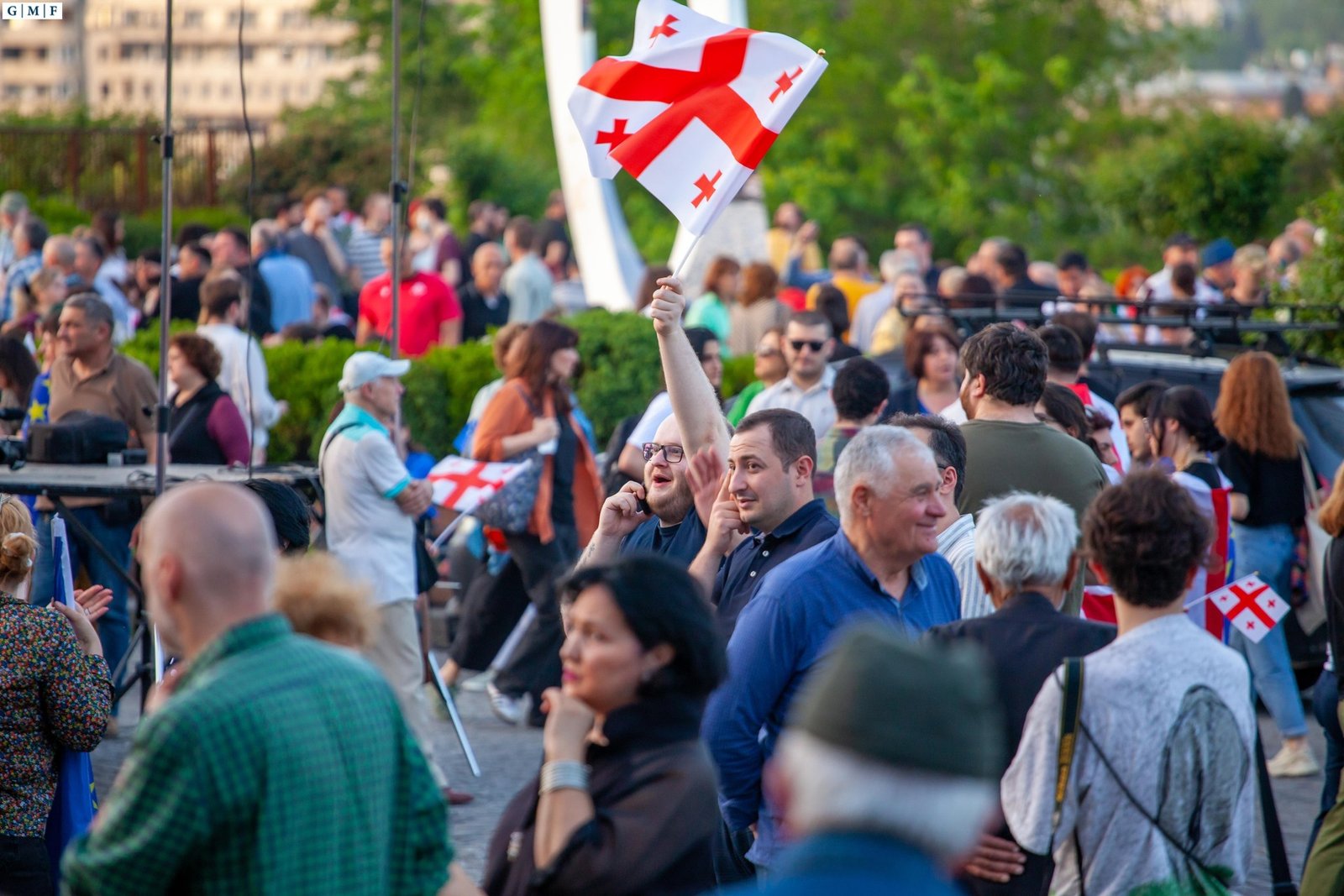 Georgian citizens at a protest waving Georgian flags - illustrates Georgia's pro-European civil society movement