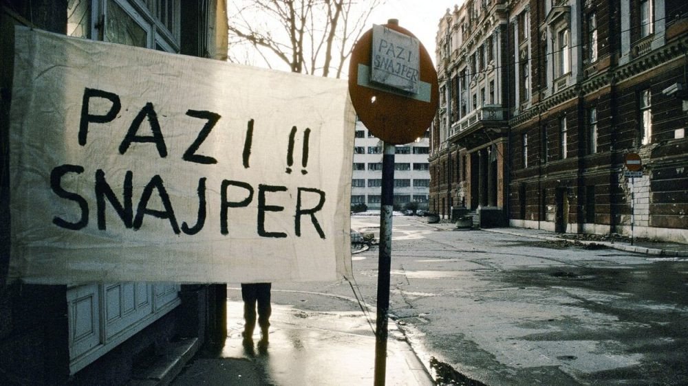 Iconic wartime photograph showing 'PAZI!! SNAJPER' (Beware!! Sniper) warning signs on Sarajevo streets during the siege