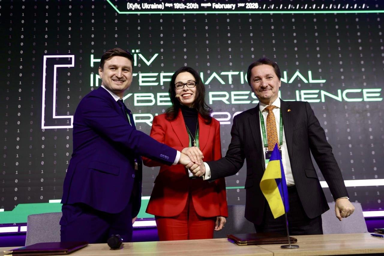 Three-way handshake between officials from Moldova, Ukraine, and Romania symbolizing the newly formed cyber alliance.