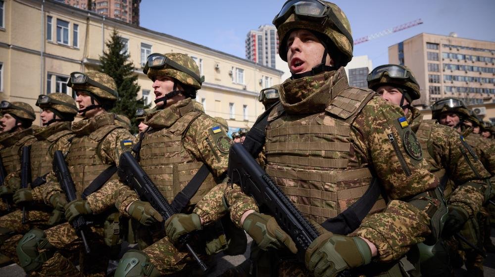 Ukrainian soldiers in combat gear marching in formation - represents military readiness and ongoing conflict