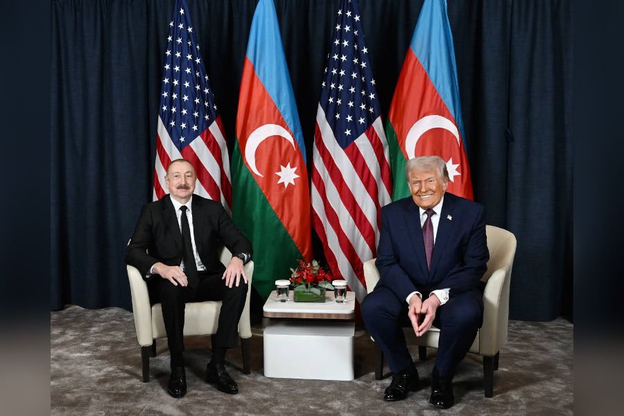 Aliyev meeting with world leader, diplomatic setting with flags