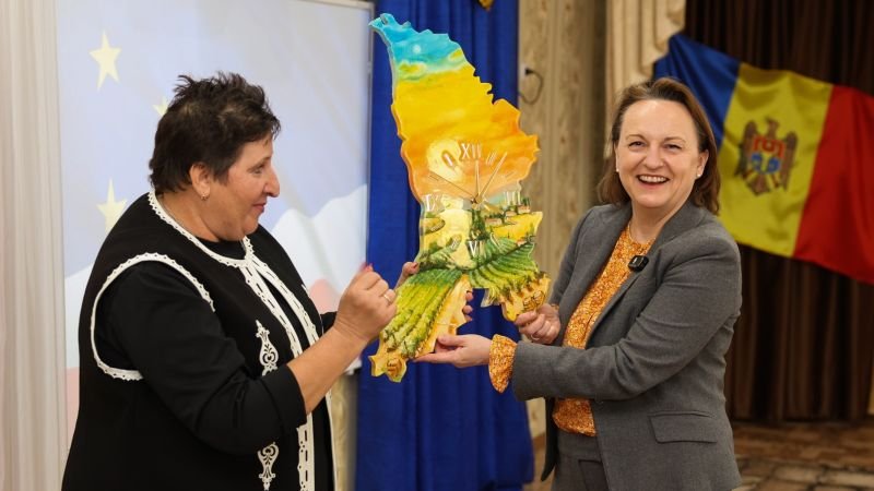 EU-Moldova cooperation event with Moldova map-shaped gift and flags, showing EU integration context