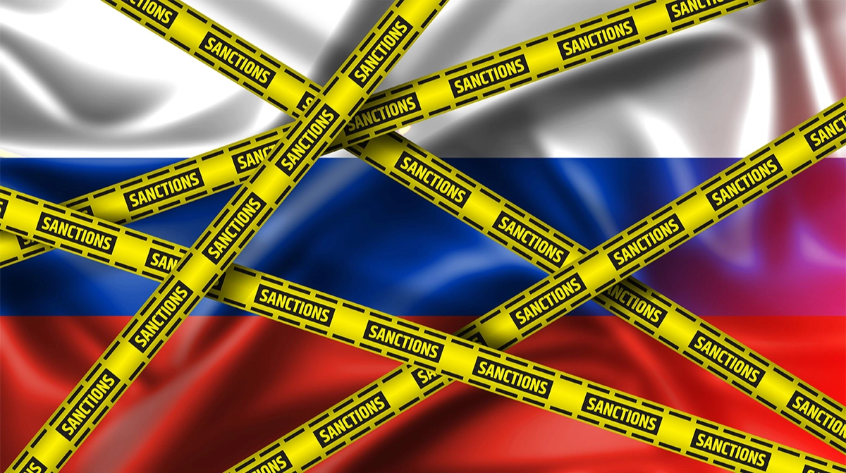 EU and Russian flags with sanctions tape overlay