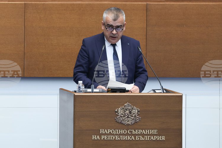 MP speaking at parliament podium with Bulgarian coat of arms