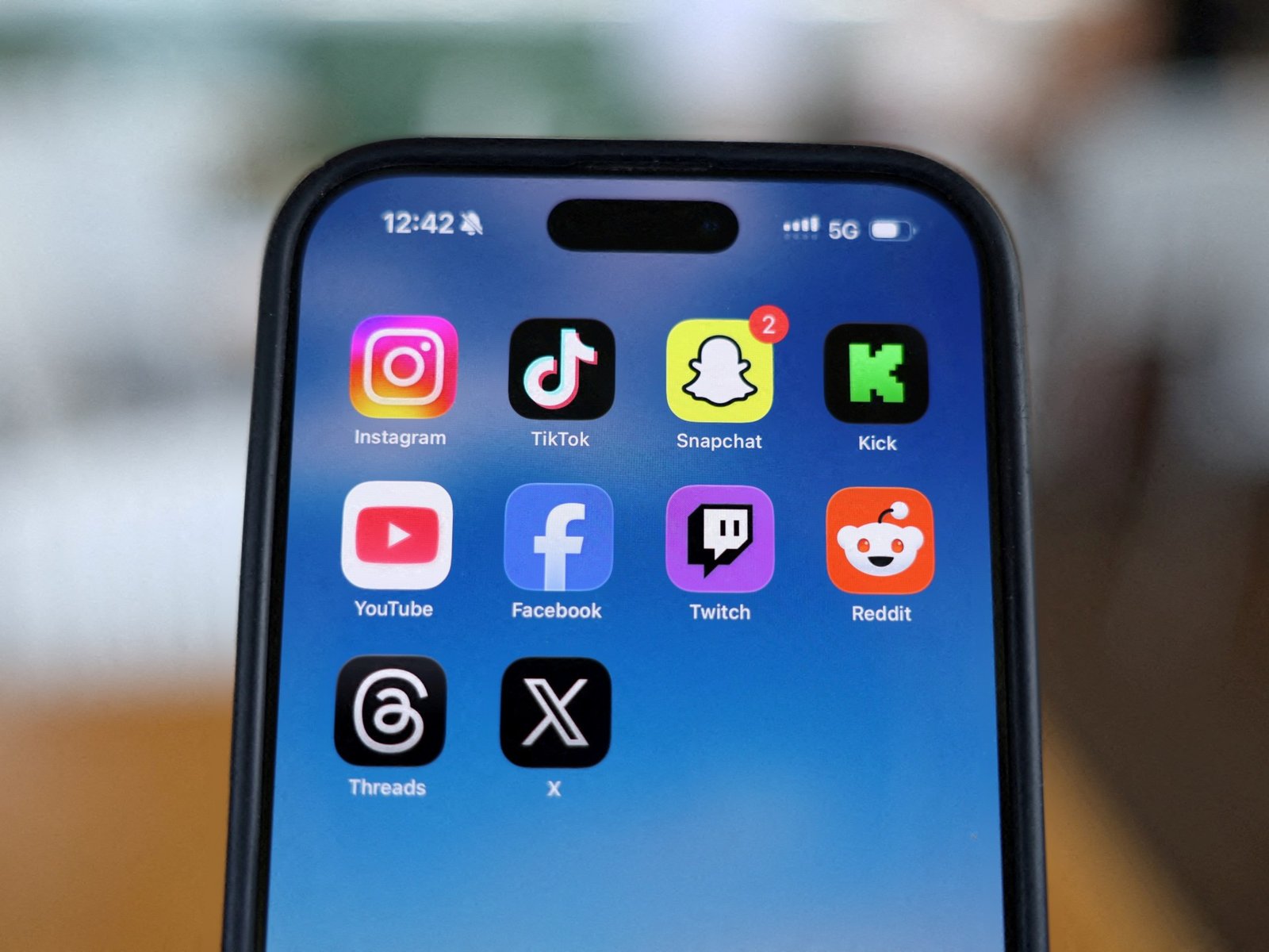 Smartphone displaying social media apps, illustrates broader context of media and information landscape