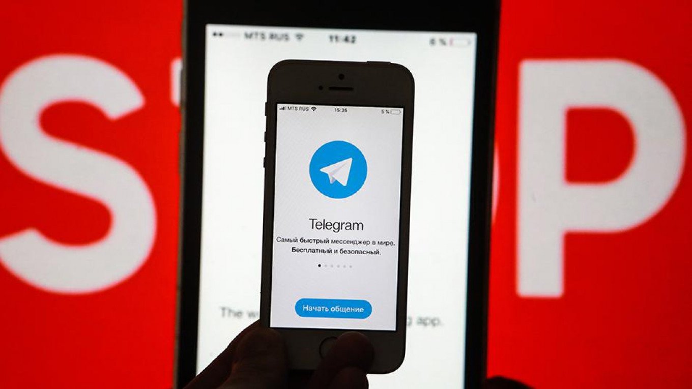 Telegram app in Russian with STOP sign background symbolizing restrictions