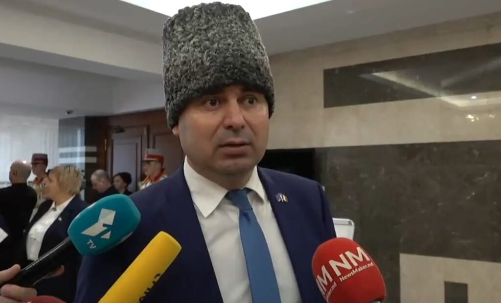 Костюк в традиционной меховой шапке дает интервью СМИ