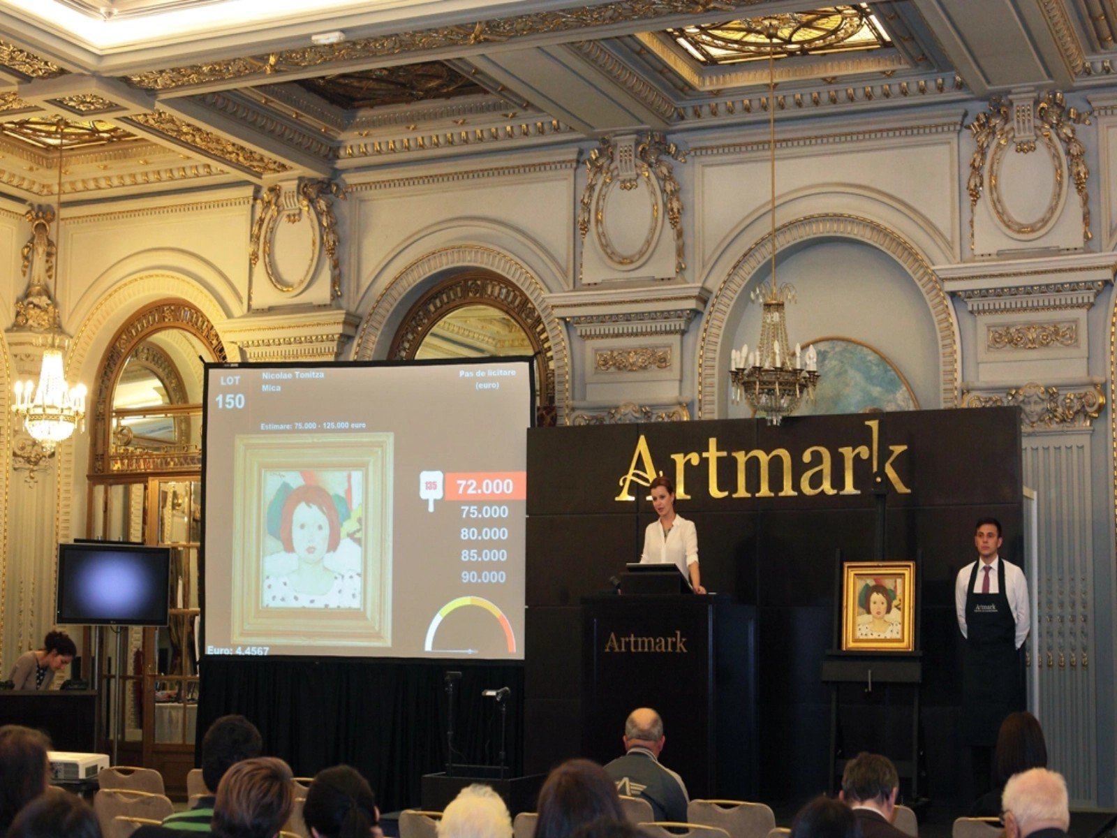 Аукционный зал Artmark с экраном ставок и картиной Григореску на подставке
