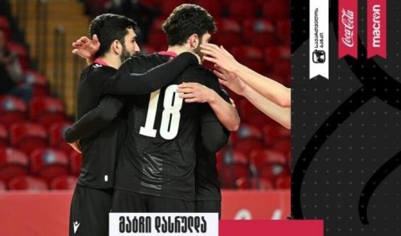 Футзалисты сборной Грузии в чёрной форме обнимаются после забитого мяча