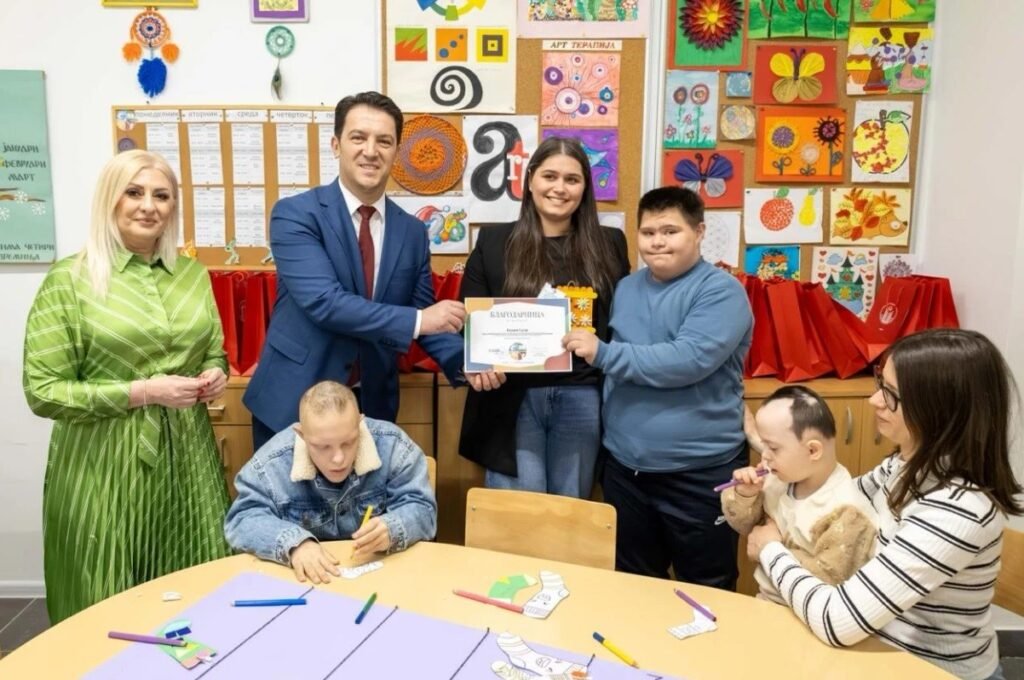 Инклюзия на словах: Северная Македония между реформой и реальностью Вице-премьер Беким Сали вручает благодарственную грамоту в ресурсном центре «Иднина» в окружении детей с синдромом Дауна во время занятий арт-терапией