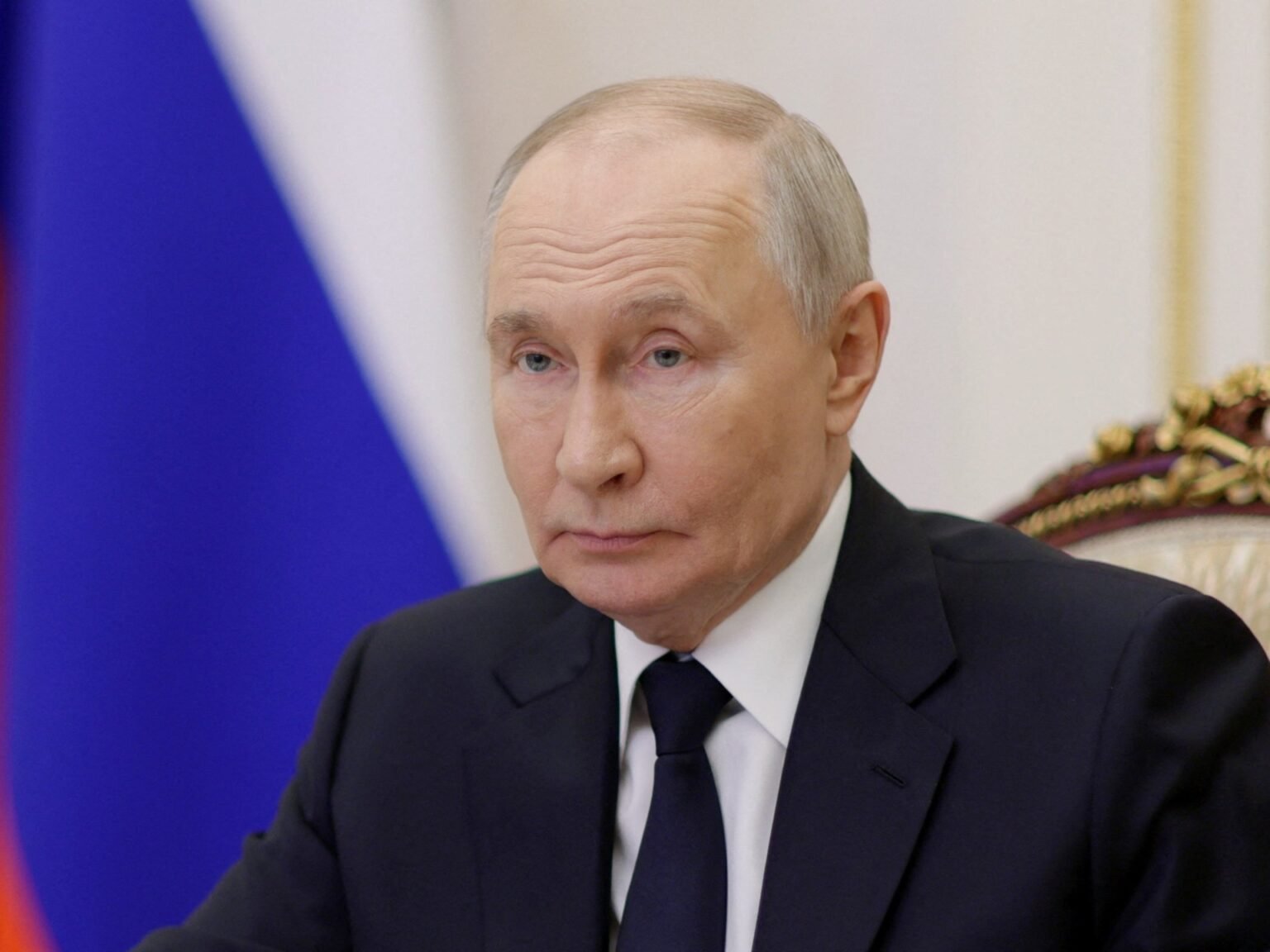 Putin portrait, high quality close-up with Russian flag in background. Фото: Al Jazeera