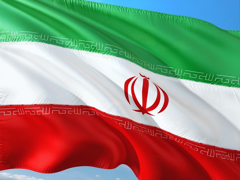 Iranian flag (Islamic Republic) waving against blue sky. Фото: Arminfo
