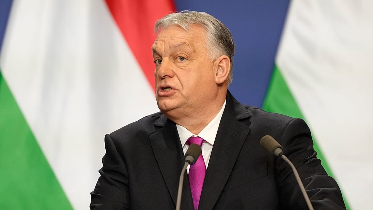 Viktor Orbán speaking with Hungarian flags behind