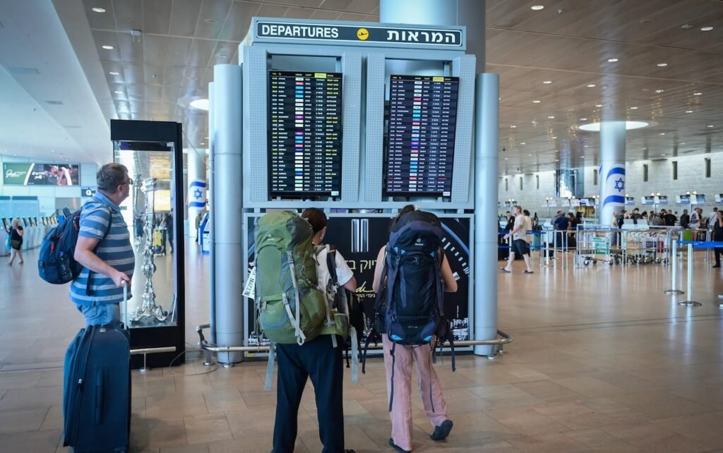 Пассажиры с рюкзаками у табло вылетов в аэропорту Бен-Гурион (Израиль). Фото: Ziarul de Garda