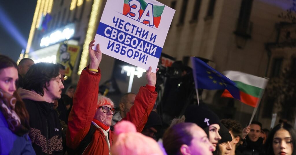 Протест в Софии за честные и свободные выборы: участница держит плакат «За честни и свободни избори!», на фоне видны болгарские и европейские флаги