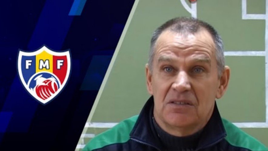 Тренер молодёжной сборной Молдовы U21 на фоне эмблемы Федерации футбола Молдовы (FMF)