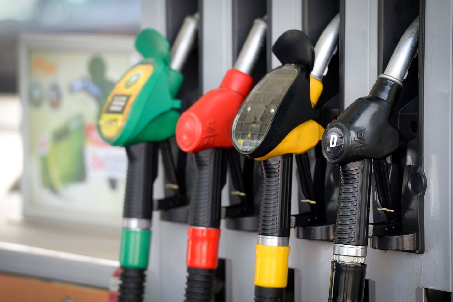 Colorful gas pump nozzles at fuel station - green, red, yellow, black. Фото: vreme.com