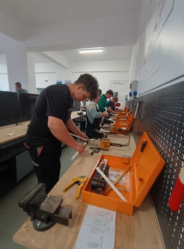 Ученики технологического лицея работают за верстаками в обновлённой слесарной мастерской с профессиональным инструментом