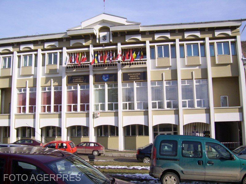 Здание Совета жудеца Ковасна с национальными и международными флагами на фасаде