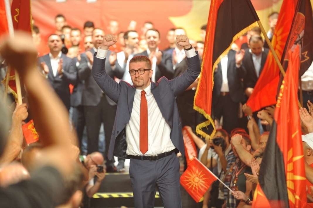 Лидер ВМРО-ДПМНЕ Христиан Мицкоски на партийном митинге среди сторонников с флагами Северной Македонии