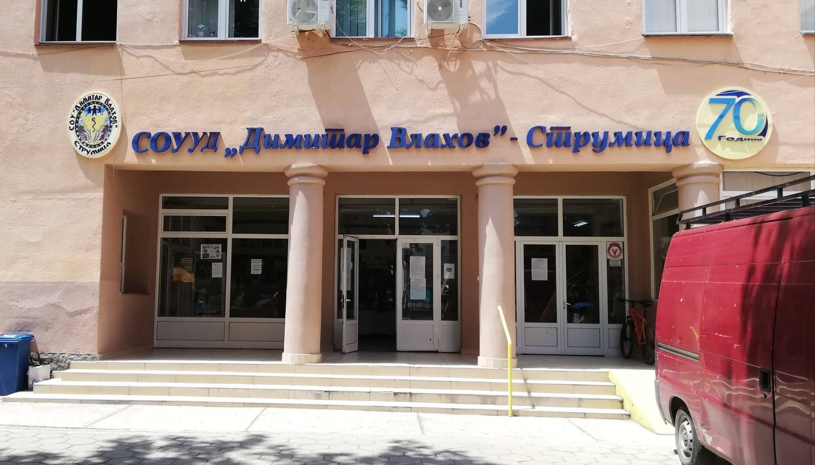 Главный вход СОУУД &laquo;Димитар Влахов&raquo; в Струмице с эмблемой школы и юбилейным знаком &laquo;70 лет&raquo; над входной группой