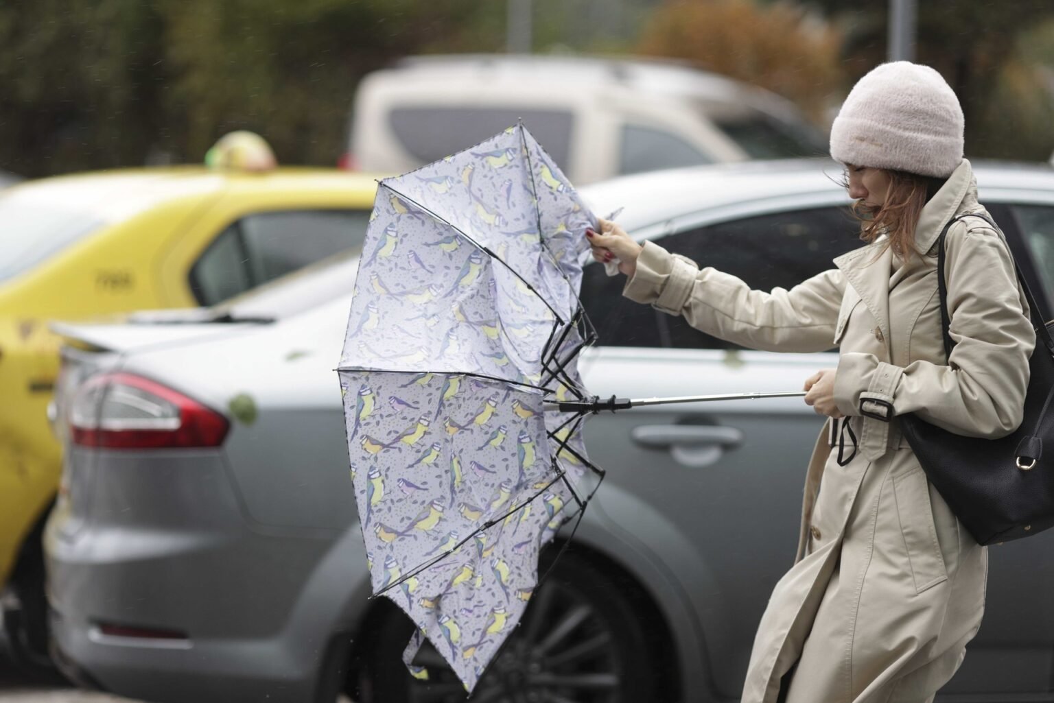 Женщина с вывернутым зонтом на ветру