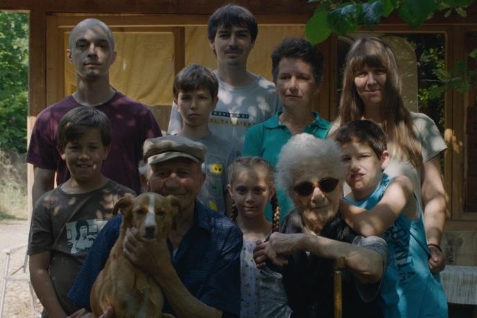 Кадр из сербской ленты основной конкурсной программы Pulskog filmskog festivala: трёхпоколенная семья позирует у деревянной веранды загородного дома, на руках у дедушки маленькая собака