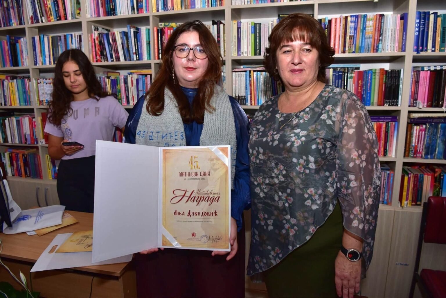 Аня Давидович из Белграда получила «Матичев шал» Аня Давидович держит диплом премии «Матичев шал» рядом с директором Народной библиотеки «Душан Матич» в Чуприи; на плечах поэтессы вручённый вязаный шарф